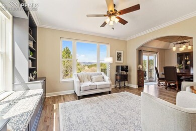 Living area featuring arched walkways, wood finish
