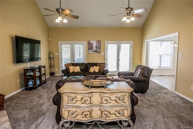 View of family room from foyer. Doors to screened 