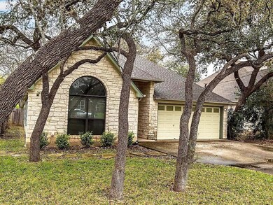 View of front of property with stone siding, a sh