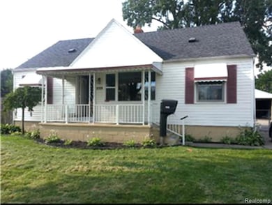 Bungalow-style house with a front yard and a porch