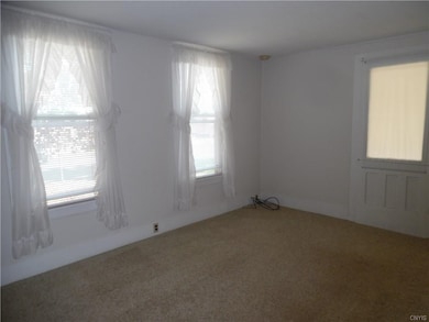 Another view of the living room and a door as you 