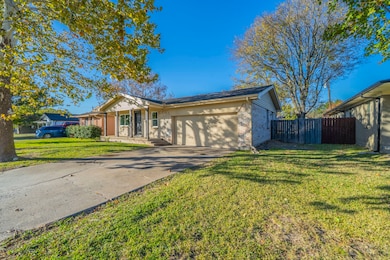Single story home featuring concrete driveway, brick siding, and a garage