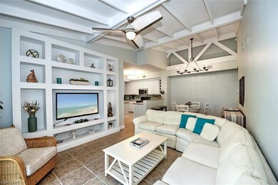 Living room featuring vaulted ceiling with beams, 