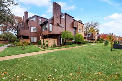 View of front facade featuring a chimney, a front yard, and brick siding