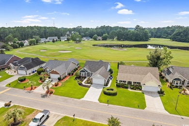 Aerial view of residential area with a large body of water and a golf course