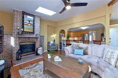 Living room w/ fireplace open to kitchen