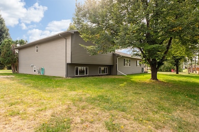 Rear view of house featuring a lawn and a patio