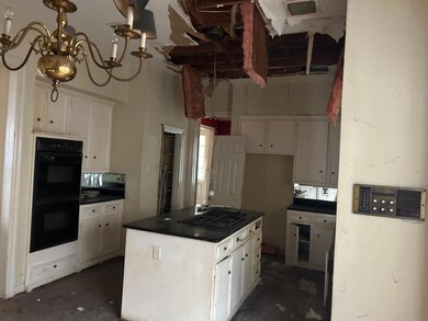 Kitchen with white cabinetry, black appliances, an