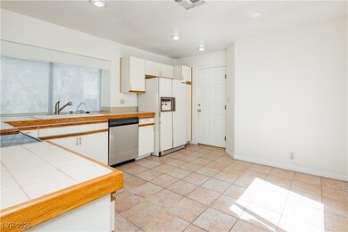 Kitchen featuring dishwasher, white fridge with ic
