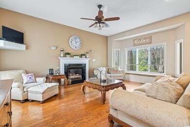 Living room with ceiling fan, a glass covered fire