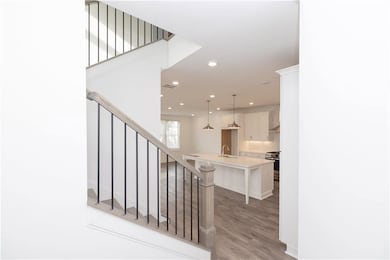 Open concept, white cabinets, 2030 sq.ft. -  pictures represent a previously built home, not the actual home.