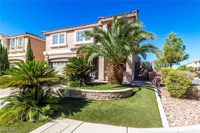 View of front facade with stucco siding, a tiled roof, and a front yard