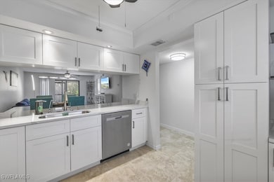 Kitchen featuring dishwasher, a ceiling fan, white