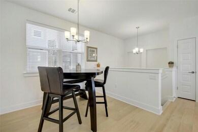 Dining area featuring a chandelier and light wood