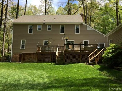 Large private back yard with lush flower beds, sto