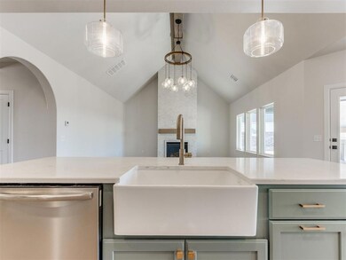 Kitchen featuring lofted ceiling, light stone coun
