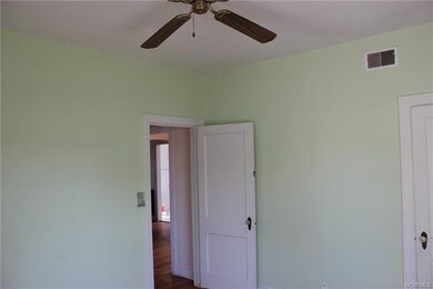 The first bedroom has a ceiling fan, hardwood floo