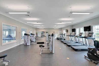 Exercise room featuring crown molding, visible vents, and baseboards