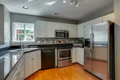 New granite, SS appliances and view to back yard