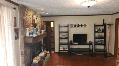 Living area with a fireplace, wood finished floors