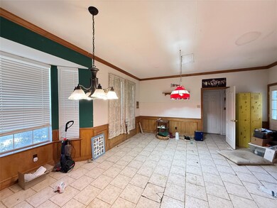 Dining space featuring a wainscoted wall, ornament