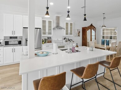 Kitchen with ample cabinets, sleek countertops, and natural light throughout.