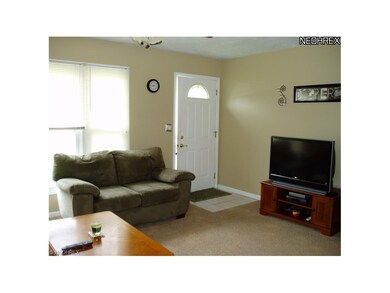 The light filled living room has a ceramic tile en