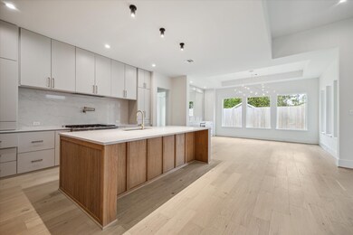 Contrasting soft grey cabinetry on the back wall o