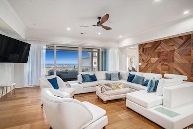 Living room featuring crown molding, ceiling fan, recessed lighting, and light wood-type flooring