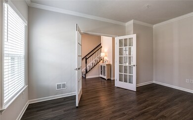 Gameroom w/crown molding & French doors.