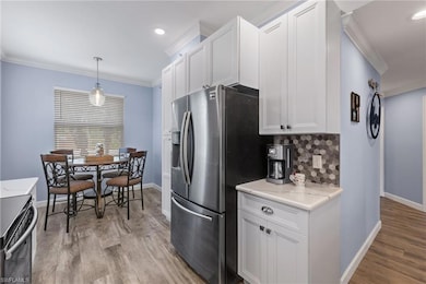 Kitchen featuring stainless steel fridge with ice 