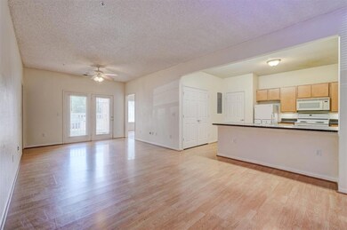 Kitchen featuring ceiling fan, light wood-type flo