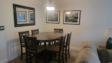 Dining room with baseboards and carpet flooring