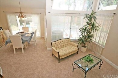 The open living room and formal dining area greet 