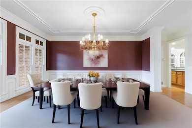 Dining area with a chandelier, ornamental molding,
