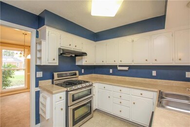 The kitchen, located off the dining room, has a dual fuel stove - gas cooking and electric ovens.
