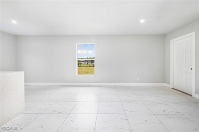 Empty room featuring light marble finish floors and recessed lighting