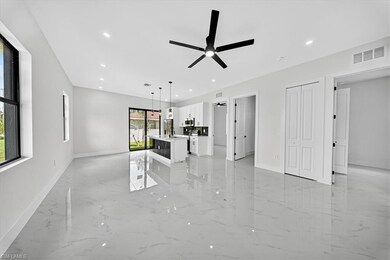 Unfurnished living room featuring light marble finish floors, recessed lighting, and a ceiling fan