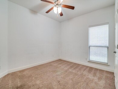 Empty room with carpet floors and ceiling fan