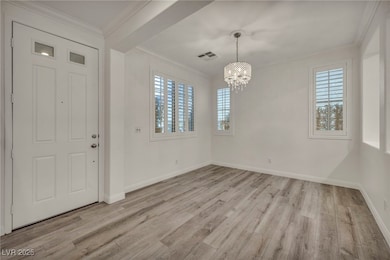 Entrance foyer featuring a chandelier, light wood-