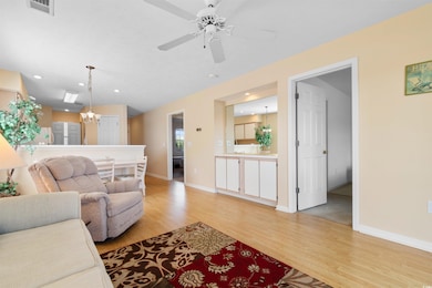 Living room featuring visible vents, baseboards, l