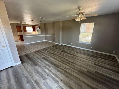 Unfurnished living room with ceiling fan, hardwood / wood-style floors, and a healthy amount of sunlight