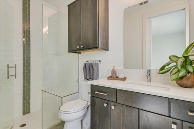 Full bathroom featuring vanity, toilet, visible v