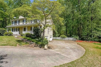 View of front of home with concrete driveway, a fr