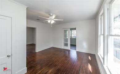 Empty room with dark hardwood / wood-style floorin
