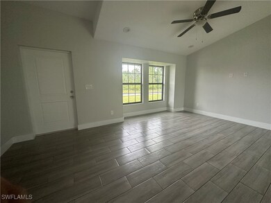 Spare room with a ceiling fan and dark wood finish