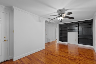 Unfurnished living room featuring crown molding, 