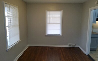 Unfurnished room featuring dark wood-type flooring