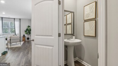 Pearson townhome half bathroom off front hallway with a pedestal sink
