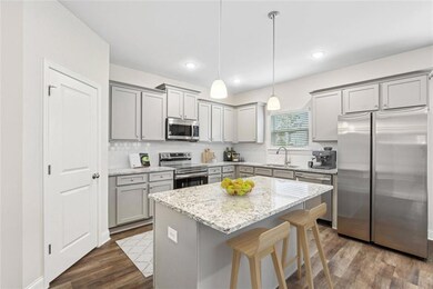 Kitchen featuring a kitchen island, pendant lighti